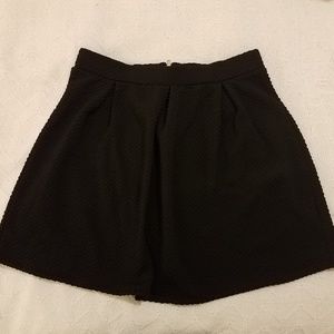 Black pleated mini skirt